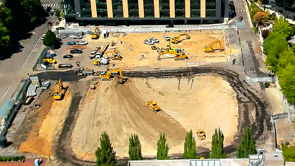 The site appears remarkably static, with equipment and materials maintaining their positions from the previous view.