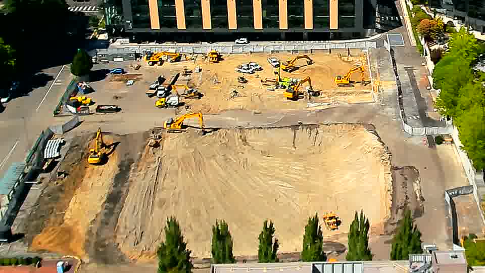 The scene remains largely unchanged, with the positioning of equipment and materials appearing consistent across the site.