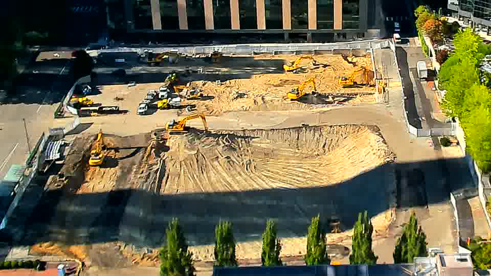 The site continues to show a similar arrangement of machinery, with only minor shifts in shadow patterns across the graded area.