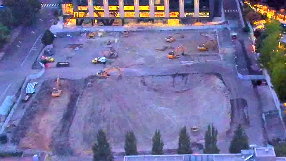 The site is now visible with the increasing light, revealing equipment in roughly the same positions as before.
