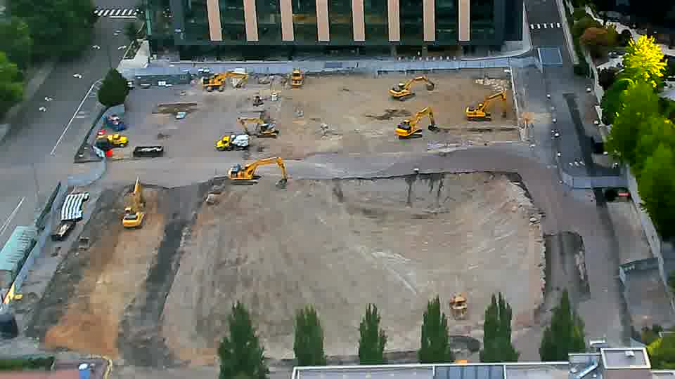 Equipment across the site remains in largely the same arrangement as fifteen minutes ago.