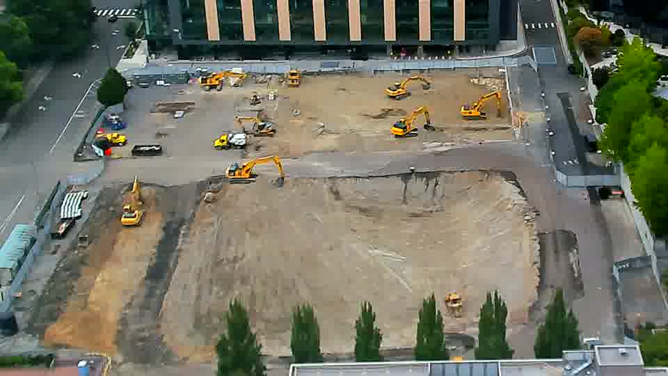 The scene is remarkably similar to the previous view, with no immediate changes in the positions of the heavy equipment.
