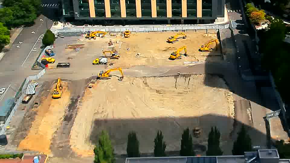 The shadows have lengthened across the site, but the positions of the machines appear unchanged from the last view.