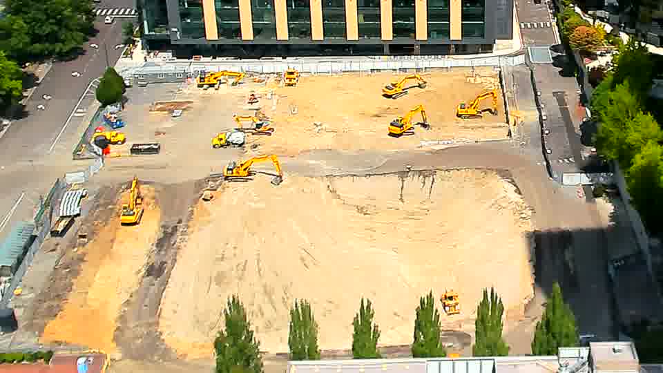 The arrangement of heavy machinery across the site appears consistent, showing no significant shifts in position over the past few minutes.
