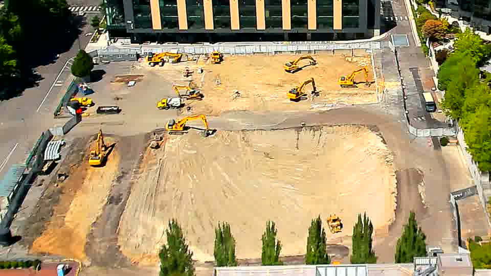 The layout of equipment on the graded area appears static, with no noticeable shifts in position over the last fifteen minutes.