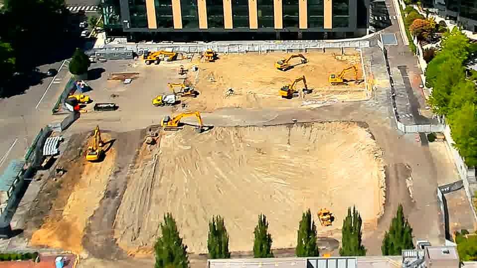 The site’s arrangement of machinery and materials remains largely the same as it was fifteen minutes ago.