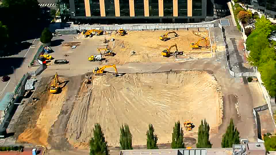 The site maintains a similar appearance, with the positions of the machines and materials appearing consistent between views.
