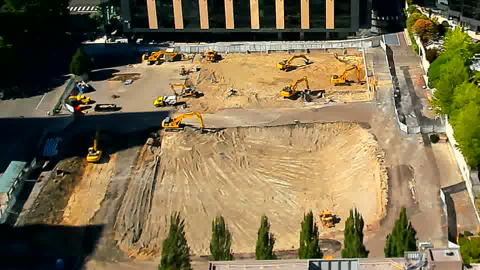The scene remains remarkably stable, with the arrangement of heavy machinery appearing unchanged.