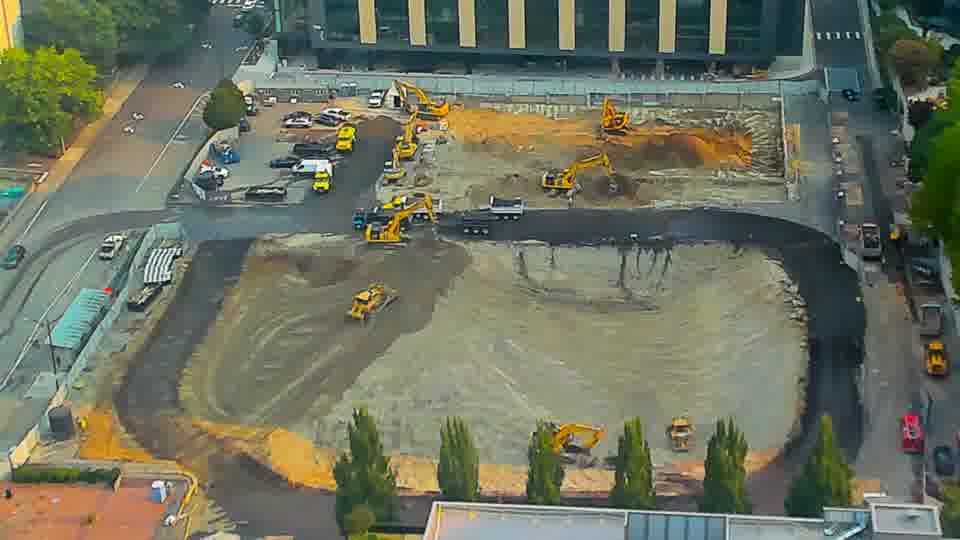 The scene is remarkably consistent, showing no substantial movement of machinery or materials in the last quarter hour.