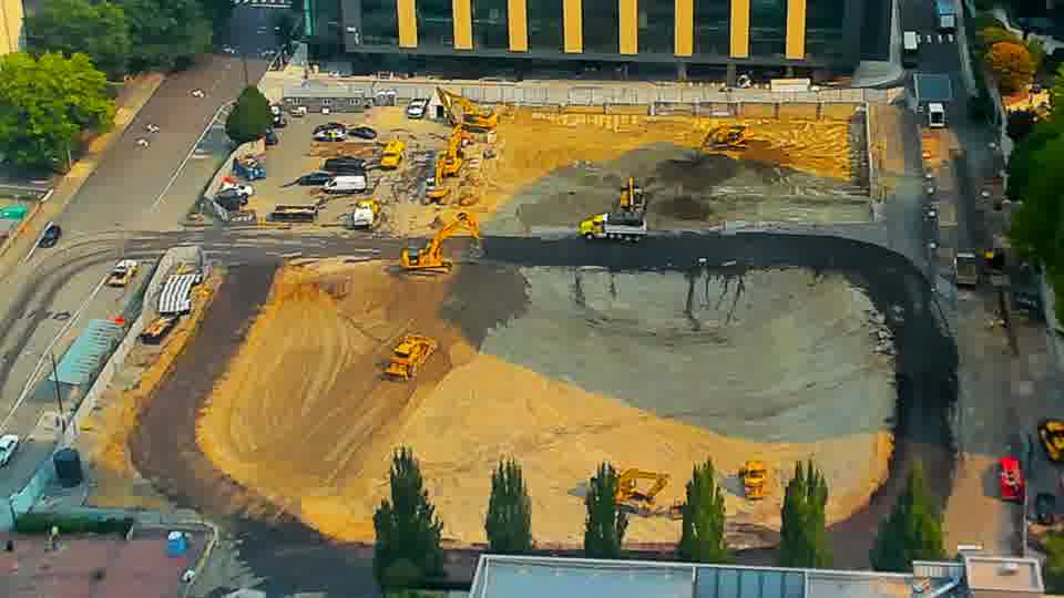 Activity on the site is minimal, with the arrangement of machinery appearing consistent between these views.