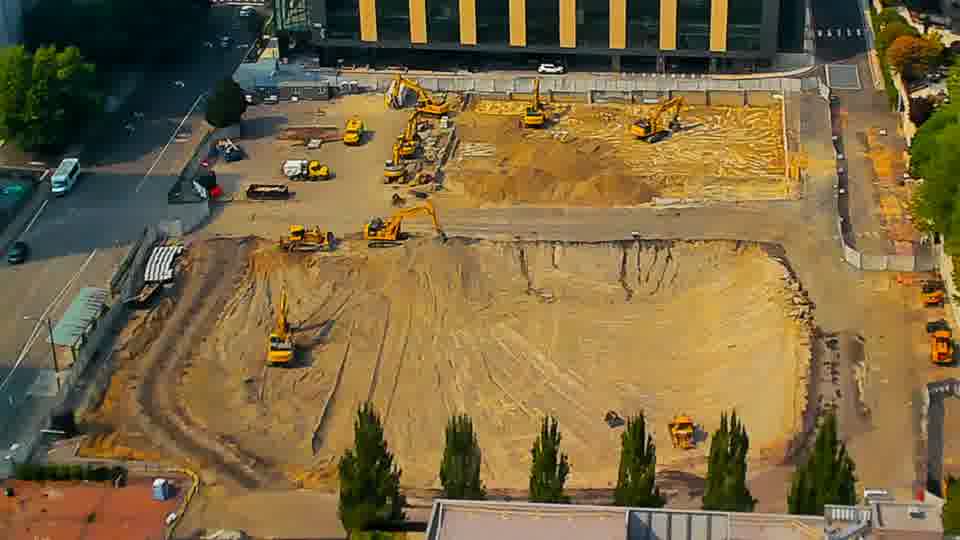 A single vehicle has entered the site via the driveway on the left side of the frame.