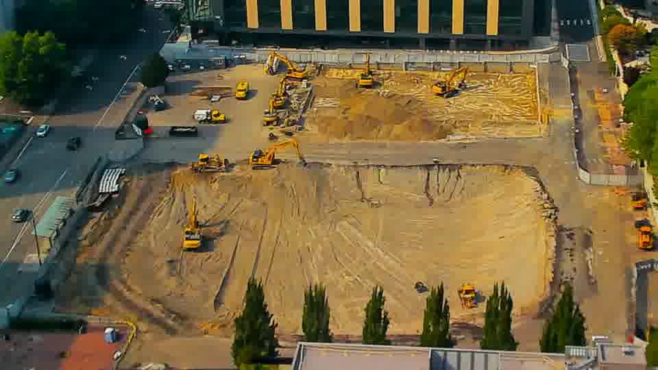 The scene presents a consistent appearance, with the arrangement of heavy machinery appearing unchanged over the last fifteen minutes.