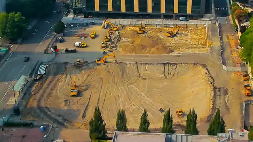 The arrangement of equipment remains stable, though one of the excavators near the center of the site has slightly altered its position.