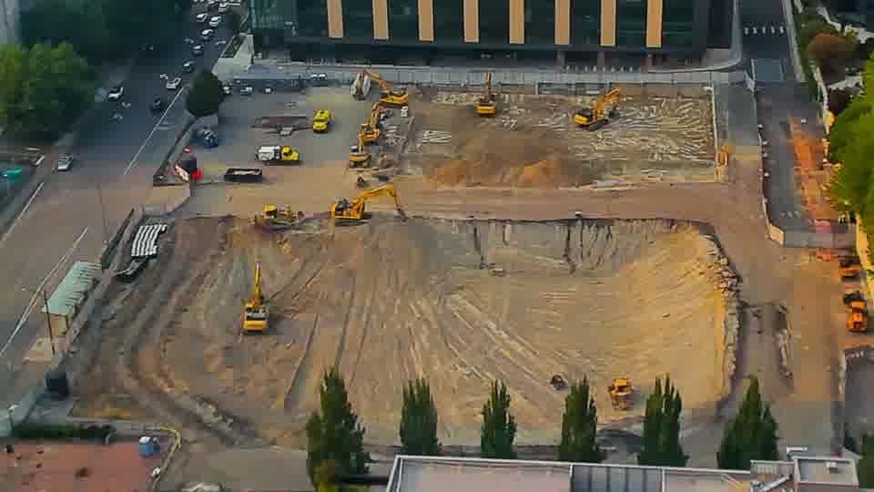 The layout of the site remains stable, with all visible machinery holding its position between these frames.
