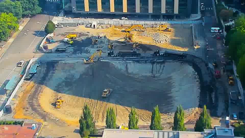 An additional piece of equipment is now visible working in the southern portion of the graded area.
