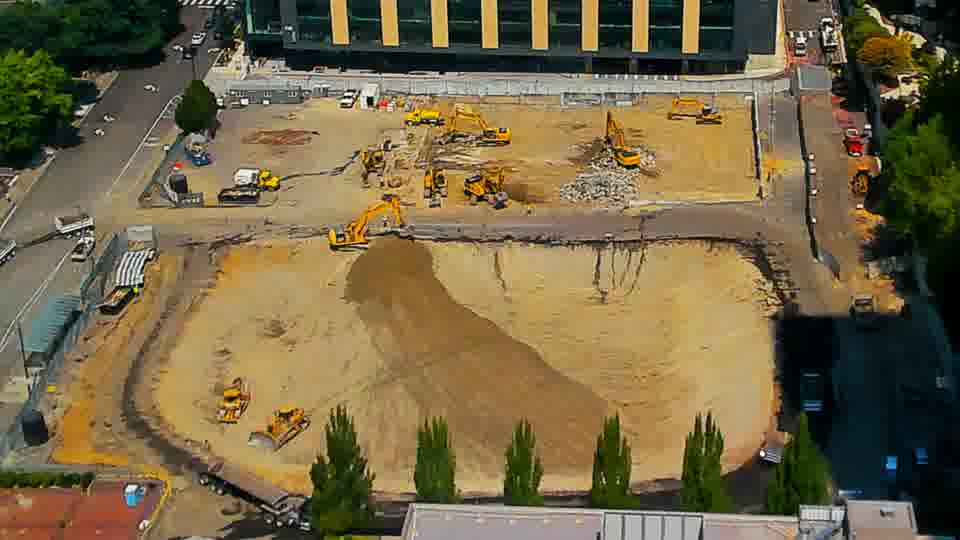 The graded area near the center of the site shows continued reshaping, with a slightly different contour to the worked surface.