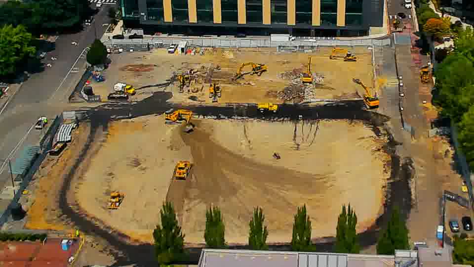 The arrangement of equipment across the site appears largely unchanged, though the worked surface shows subtle shifts in texture.