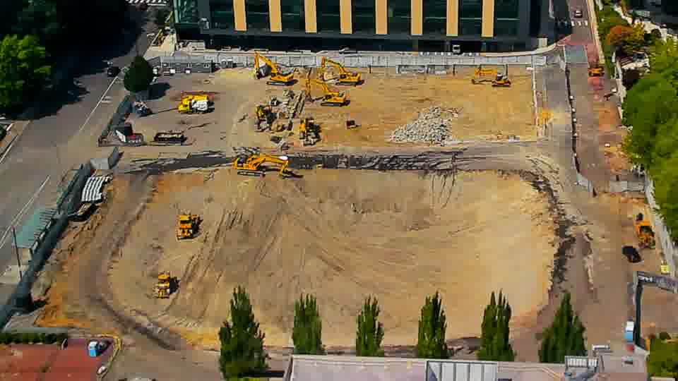 A small yellow machine has shifted position in the southwestern corner of the site, moving slightly closer to the center.