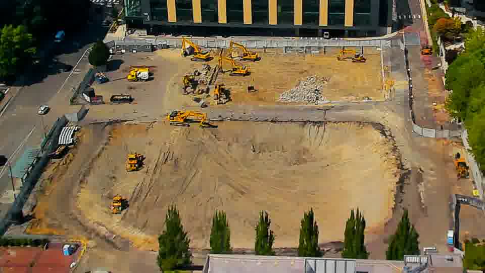 The arrangement of equipment appears largely unchanged, though the texture of the worked ground in the center has subtle variations.