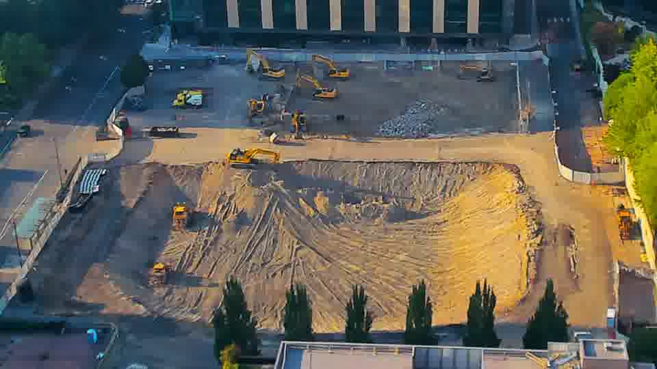 The site appears quiet, with no noticeable repositioning of equipment or materials over the last fifteen minutes.