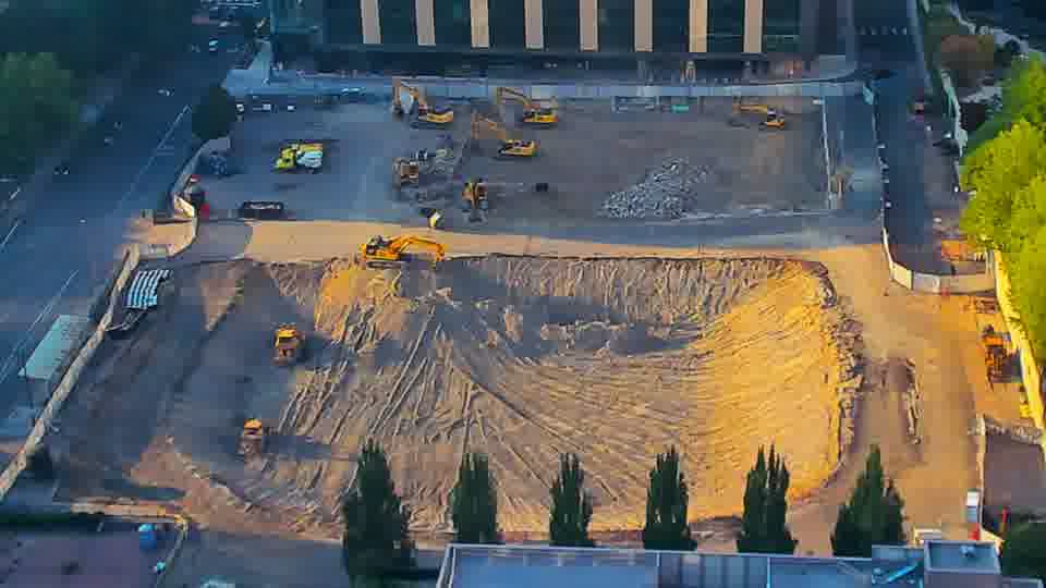 The equipment arrangement remains consistent, though the angle of sunlight continues to alter the shadows across the site.