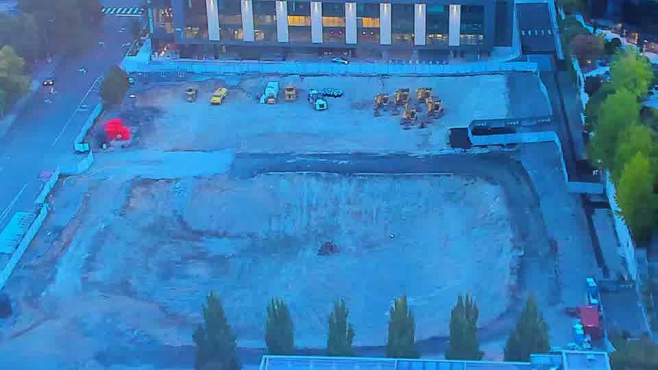 Construction camera frame at 6:45 AM PT. The scene appears static, with no discernible changes in equipment positions or activity over the last fifteen minutes.
