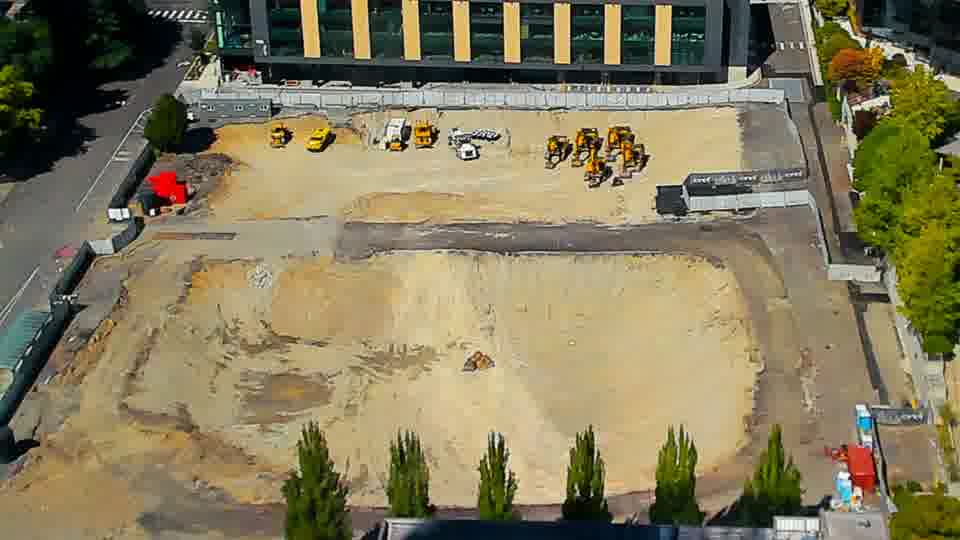 Construction camera frame at 2:15 PM PT. The site maintains a consistent appearance, with no visible movement of machinery or materials in the last fifteen minutes.