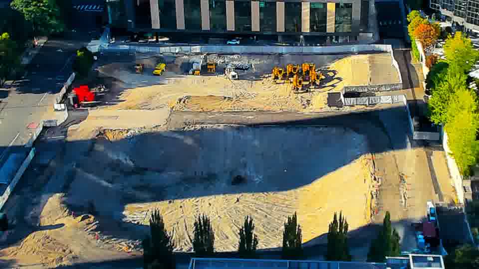 Construction camera frame at 5:45 PM PT. The site's overall layout remains consistent, showing no significant movement of equipment or materials in the intervening time.