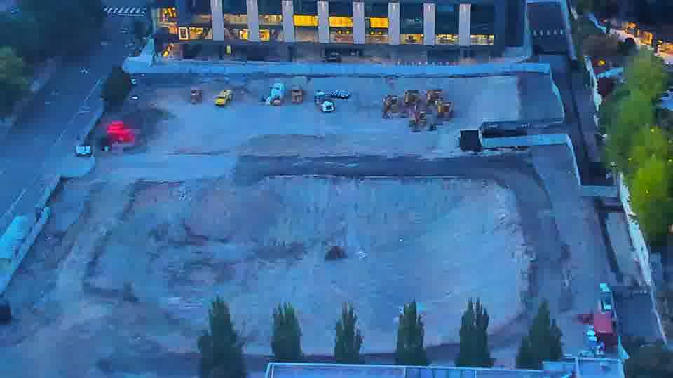 Construction camera frame at 7:45 PM PT. Equipment positions across the site are holding steady, with no visible movement in the last quarter hour.