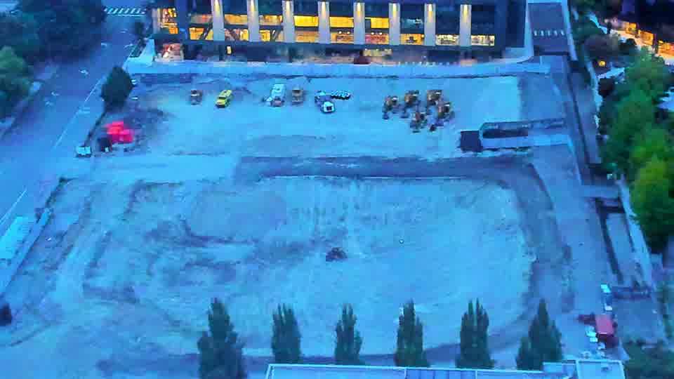 Construction camera frame at 6:45 AM PT. Visibility remains low, and the site appears quiet with no discernible shifts in equipment positioning.
