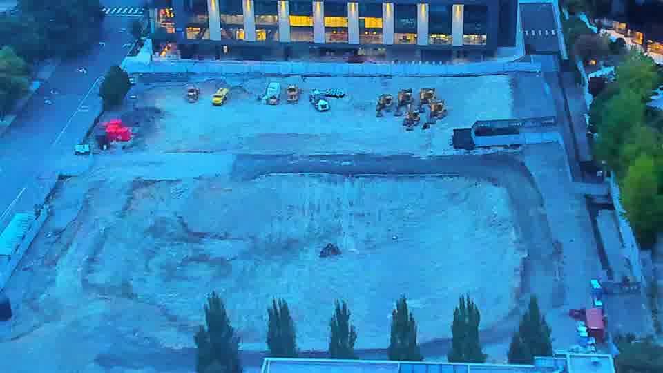 Construction camera frame at 7:00 AM PT. The scene appears static, with no noticeable movement of equipment or vehicles in the last fifteen minutes.