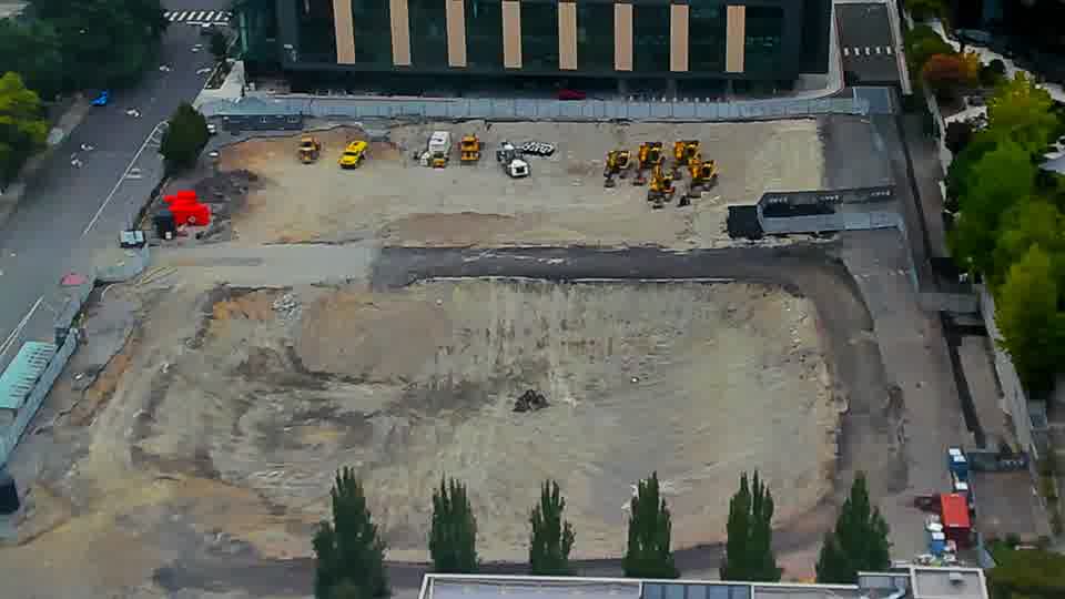 Construction camera frame at 11:45 AM PT. The site presents a static view, with all equipment and materials holding their positions from the previous check.