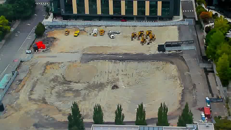 Construction camera frame at 1:15 PM PT. The construction site remains in a similar condition, with no noticeable movement of equipment or materials.
