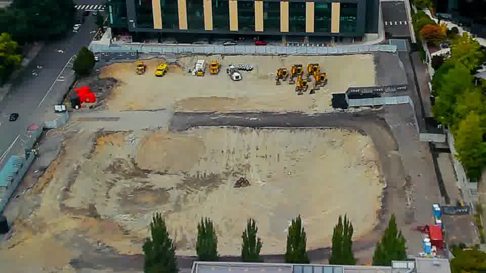 Construction camera frame at 2:00 PM PT. The site’s features remain largely static, with all visible equipment and vehicles occupying the same positions as before.
