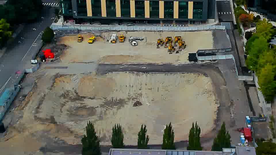Construction camera frame at 2:15 PM PT. The site presents a largely unchanged panorama, with equipment remaining in the same locations as before.