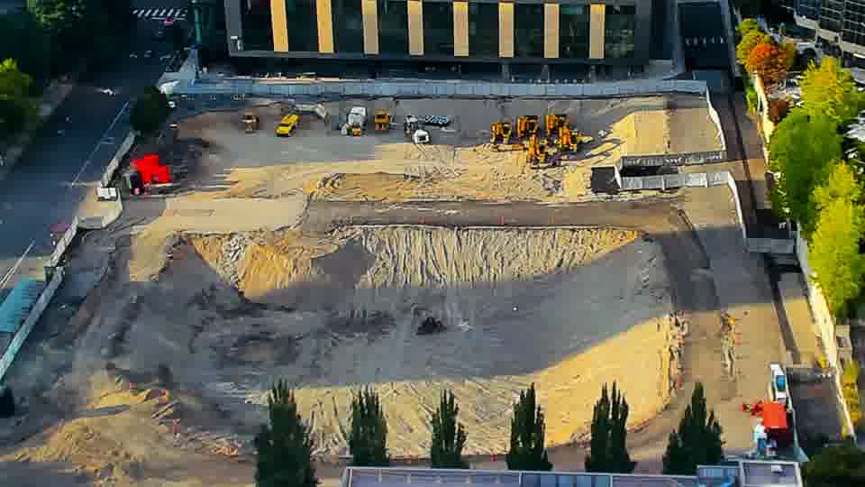 Construction camera frame at 6:00 PM PT. The arrangement of equipment across the site remains as it was fifteen minutes ago.