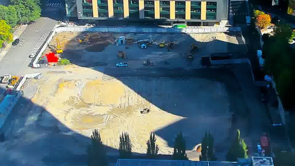 Construction camera frame at 10:15 AM PT. The fire truck from the earlier frame is no longer visible on site. Otherwise, no visible change between these frames.