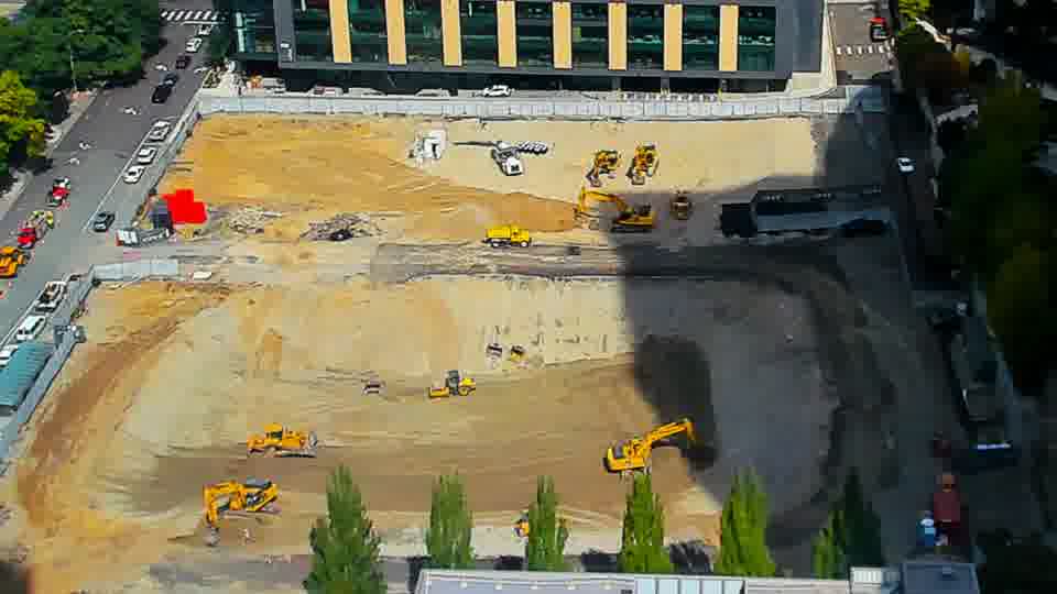 Construction camera frame at 12:15 PM PT. No visible change between these frames.