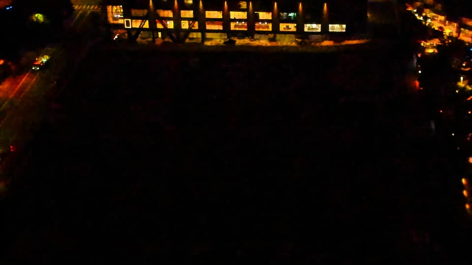 Construction camera frame at 11:00 PM PT. Visibility is too low to assess construction activity.