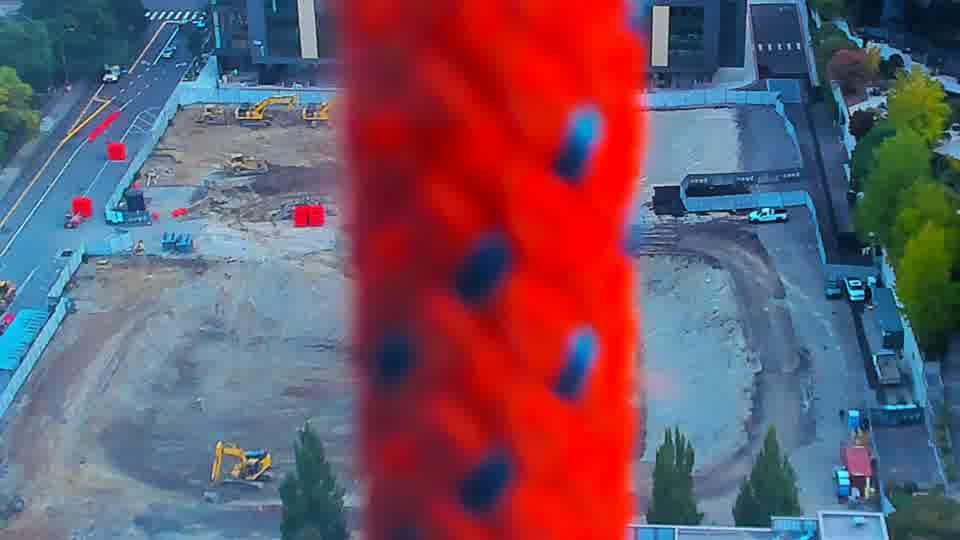 Construction camera frame at 7:30 AM PT. The view is heavily obscured by a red artifact in the current frame, making comparison difficult.