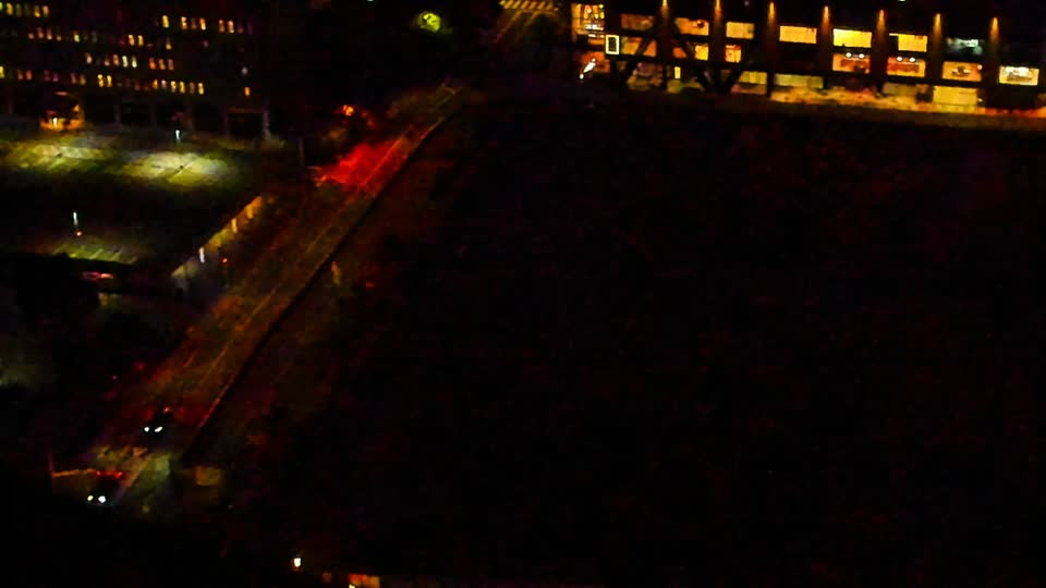 Construction camera frame at 11:00 PM PT. Visibility is too low to assess construction activity.