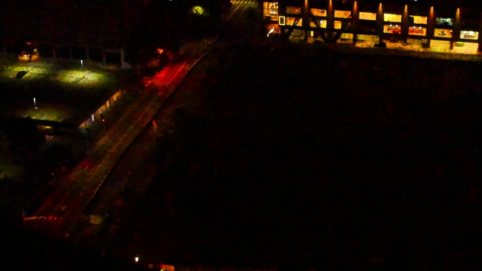 Construction camera frame at 4:00 AM PT. Visibility is too low to assess construction activity.