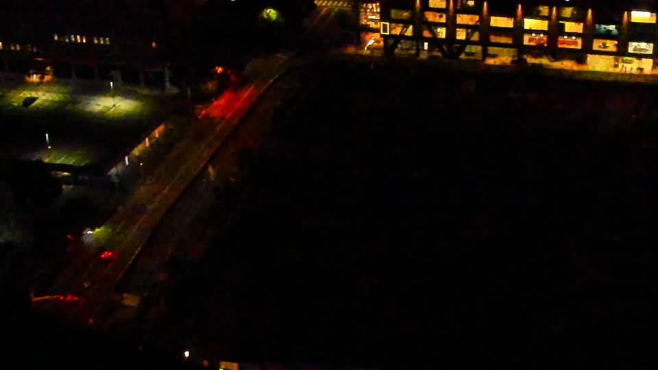Construction camera frame at 5:00 AM PT. Visibility is too low to assess construction activity.