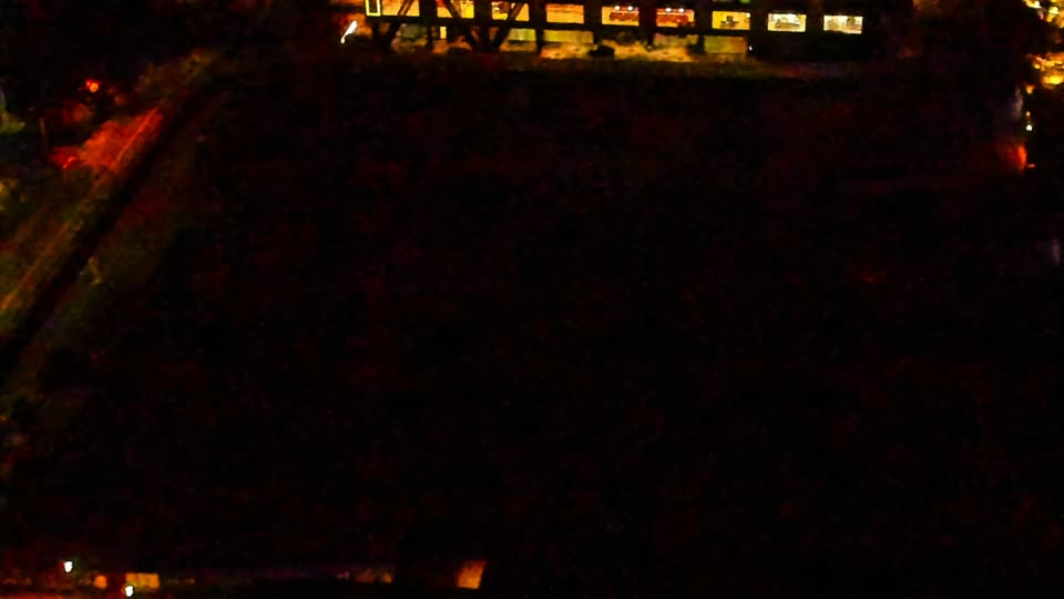 Construction camera frame at 4:00 AM PT. Visibility is too low to assess construction activity.
