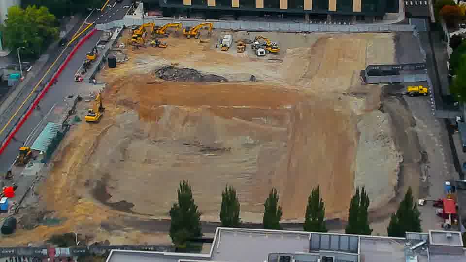 Construction camera frame at 12:15 PM PT. No visible change between these frames.