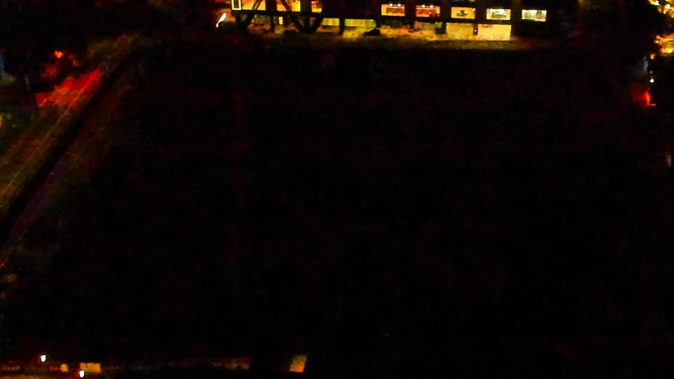 Construction camera frame at 4:00 AM PT. Visibility is too low to assess construction activity.