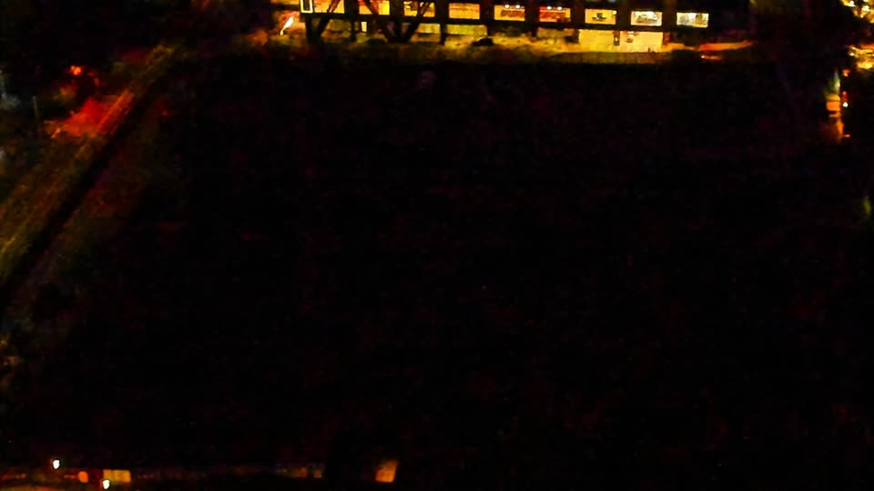 Construction camera frame at 5:00 AM PT. Visibility is too low to assess construction activity.