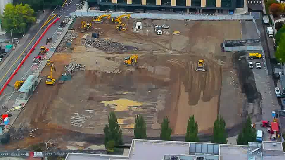 Construction camera frame at 12:15 PM PT. No visible change between these frames.