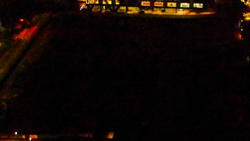 Construction camera frame at 11:00 PM PT. Visibility is too low to assess construction activity.