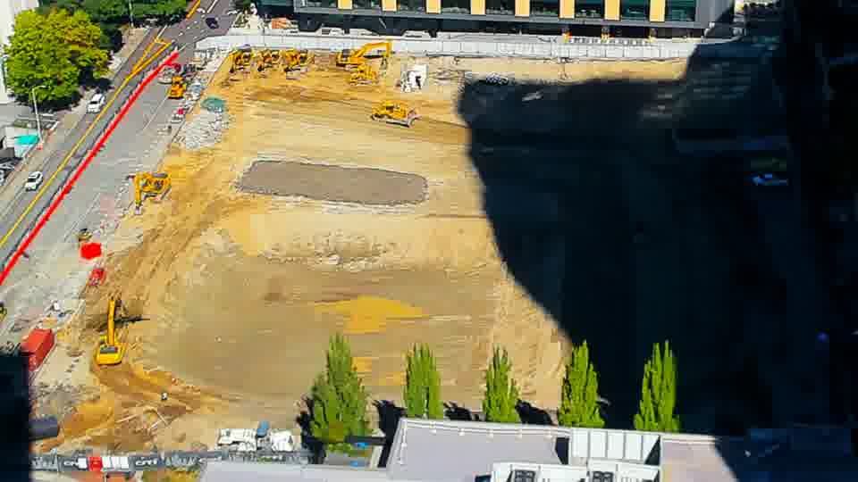 Construction camera frame at 12:00 PM PT. No visible change between these frames.